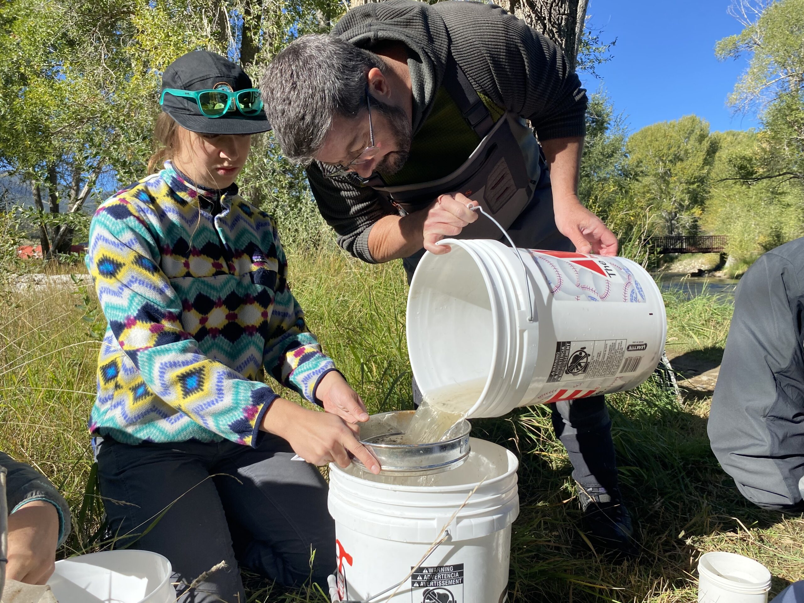 Two volunteers sampling for the River Watch Program